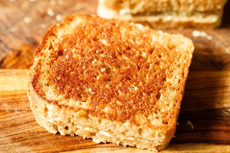 grilled cheese sandwich on wooden chopping board