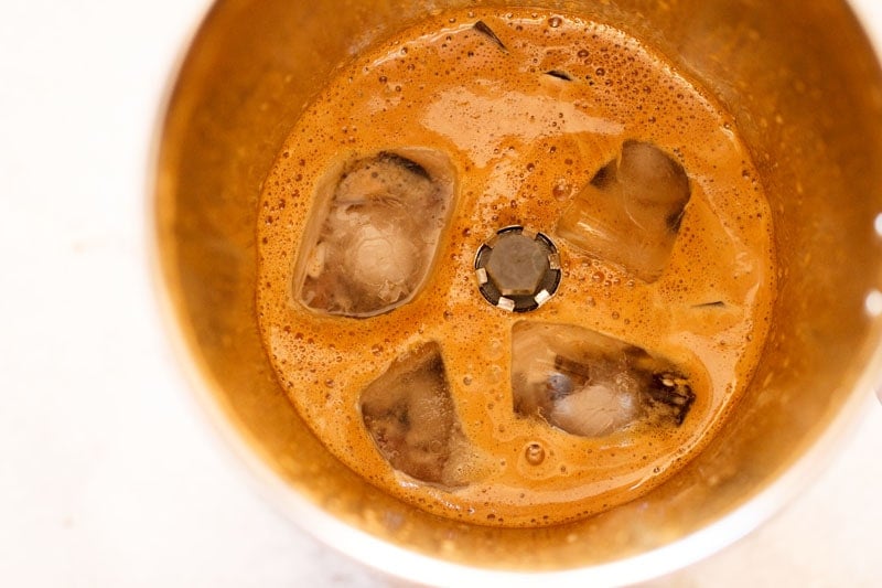 Ice cubes are added to the coffee