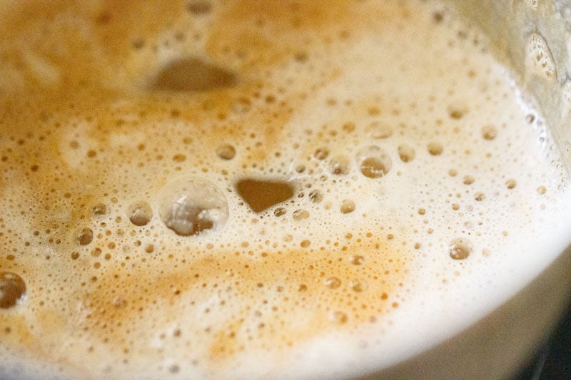 Milk is added to the frothy coffee concoction