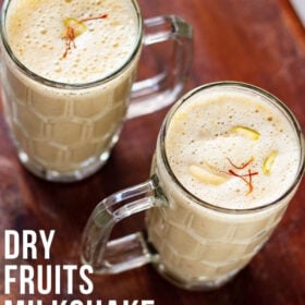 overheat shot of dry fruits milkshake recipe in two glasses with a text layover