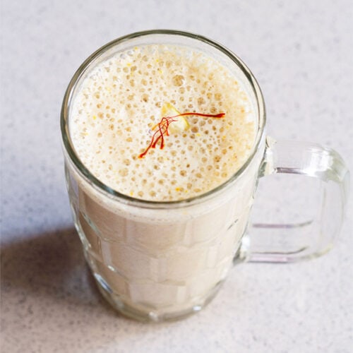 dry fruits milkshake recipe in a glass on a marbled surface