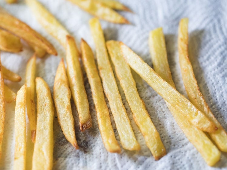 french fries draining on paper towels