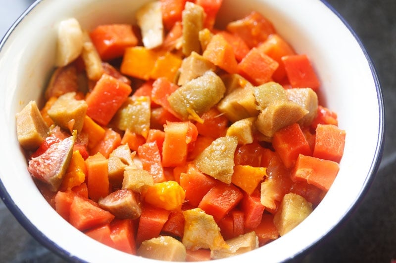 chopped fruits mixed together in a salad bowl