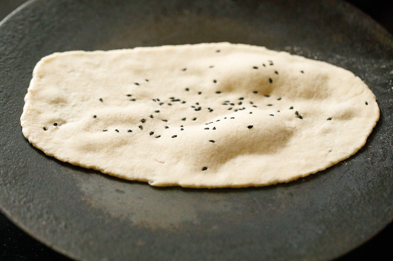 watered side rolled dough touching a hot skillet