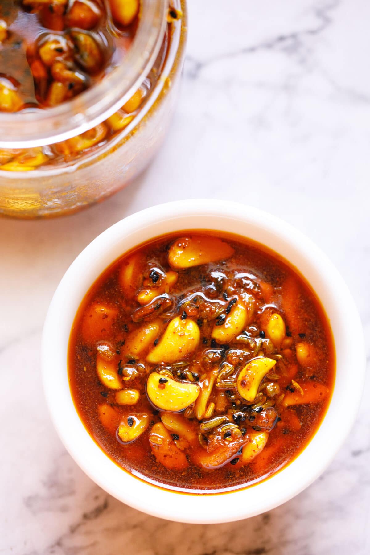 lahsun ka achaar garlic in a white bowl on a white table