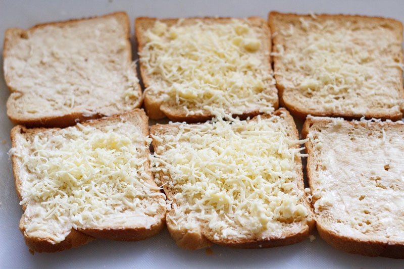 buttered bread slices topped with grated cheese