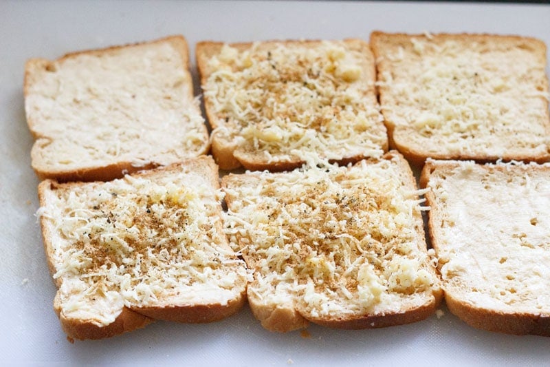 cheese on top of the buttered bread slices topped with ground spices