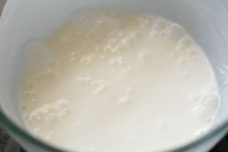 smooth whisked curd in glass bowl