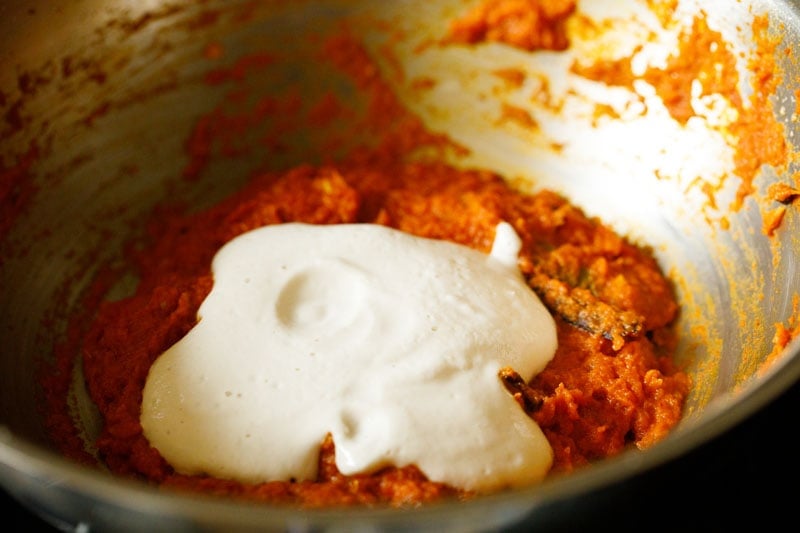 cashew paste on top of the sautéed onion tomato masala paste