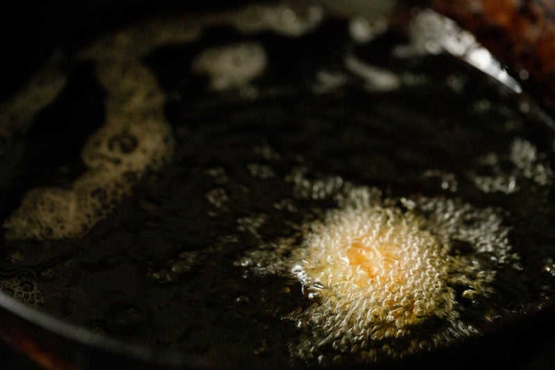 small kofta ball frying in hot oil