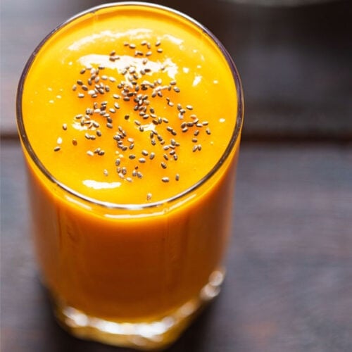mango juice in a glass topped with chia seeds