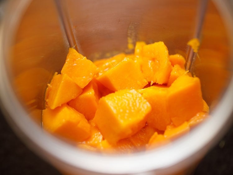 chopped mangoes in a blender