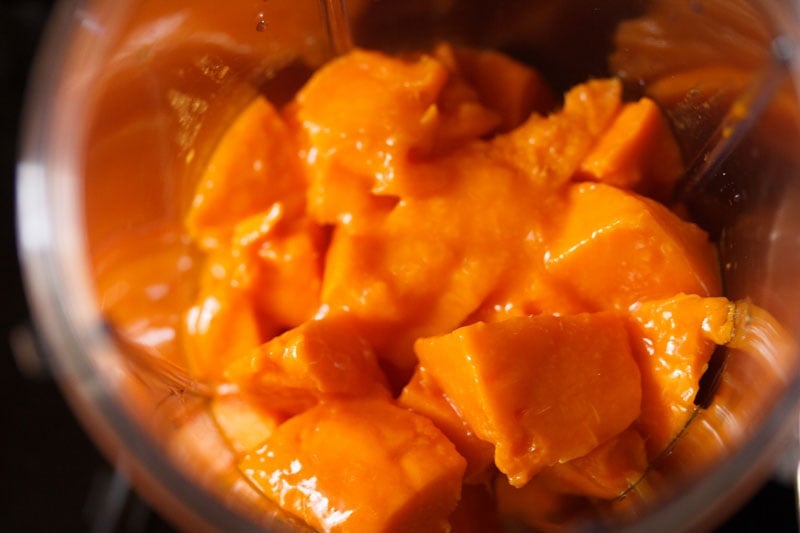 chopped mangoes in a blender