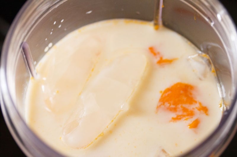 ice cubes floating on milk in blender