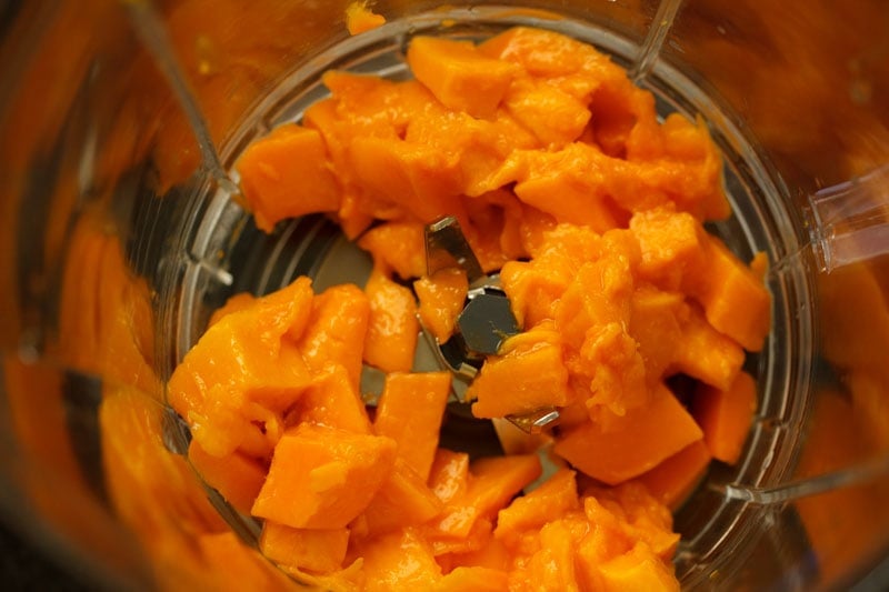 chopped mangoes in a blender