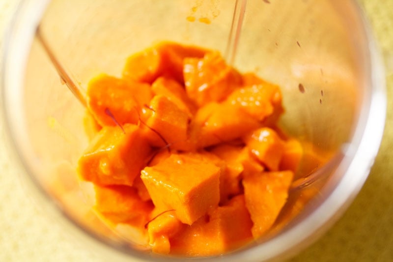 chopped mangoes in a blender