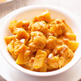 aloo gobi in a white bowl on a white board