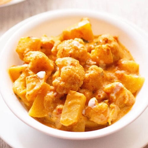 aloo gobi in a white bowl on a white board