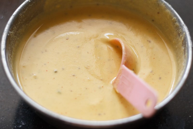 a mixture of water and dry ingredients for pakora batter