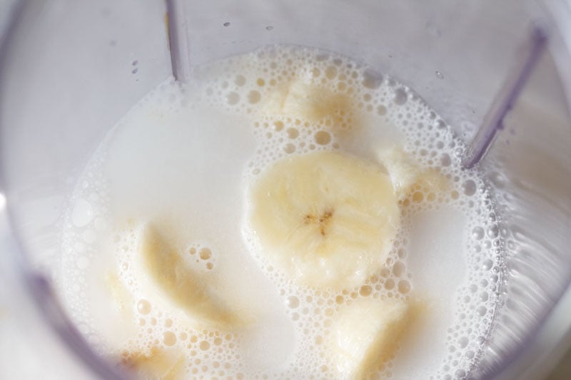thin coconut milk in the blender with the bananas