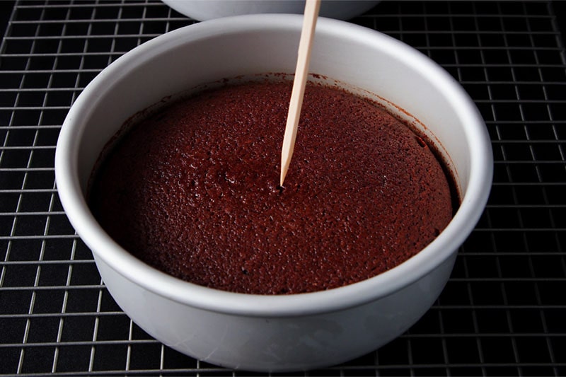 toothpick testing the doneness of the chocolate sponge cake