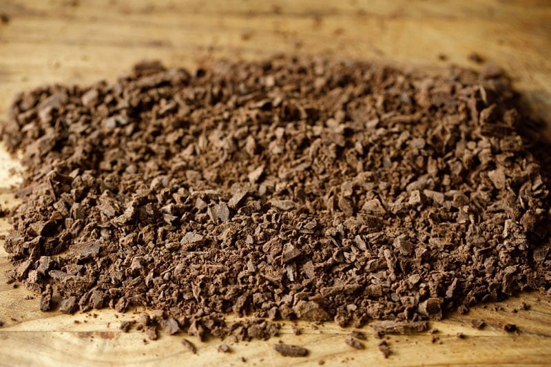 finely chopped dark chocolate on wooden tray