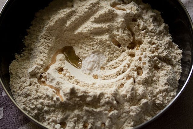 wheat flour, salt, oil in a black mixing bowl