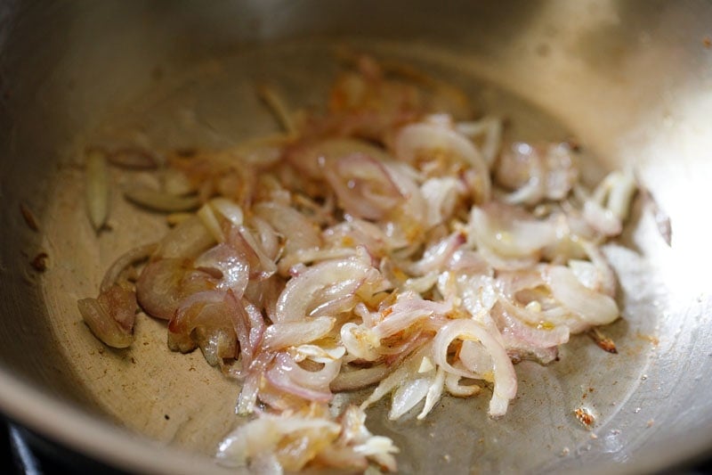 onions becoming golden in pan