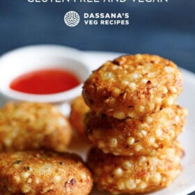 closeup shot of a stack of sabudana vada on top of each other in a white plate with red chilli sauce in a white bowl