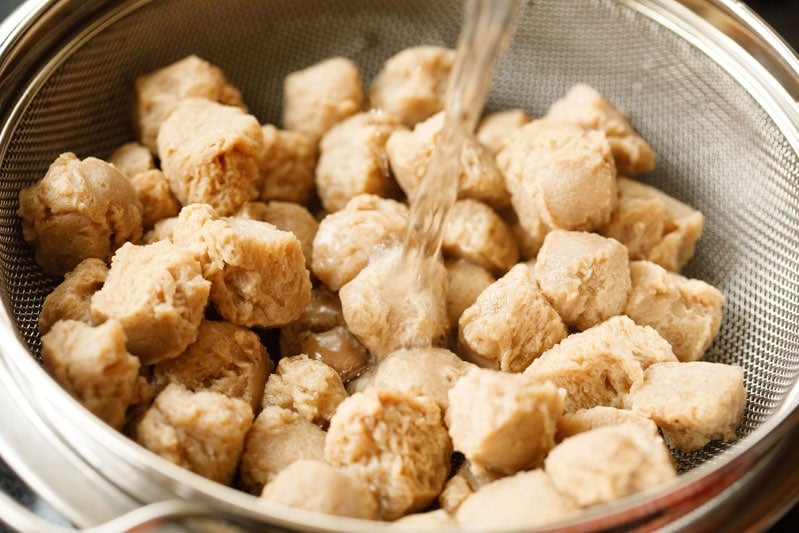 water rinsing out soaked and boiled soy chunks