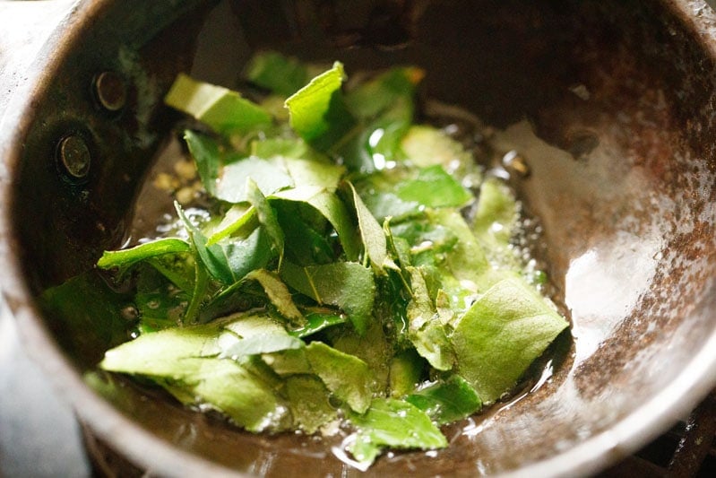 curry leaves added to wok with oil