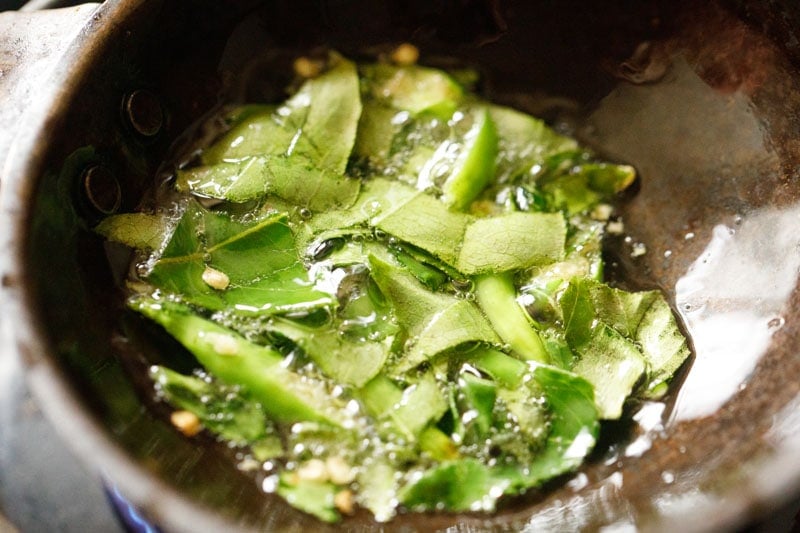 tempering curry leaves and chiles in hot oil