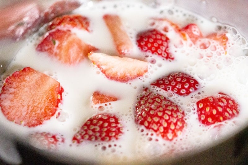milk in the blender to make strawberry milkshake recipe