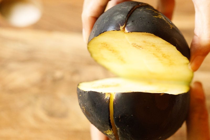 checking for worms on a pulled apart eggplant