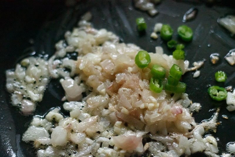 chopped green chillies and asafoetida on the sautéed onions