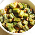 bhindi masala in a white bowl on a off white napkin