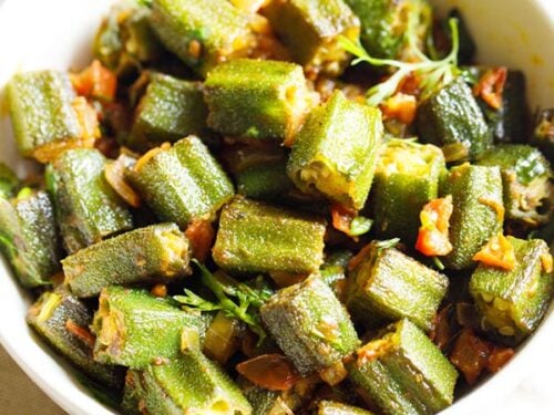 bhindi masala in a white bowl on a off white napkin