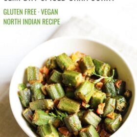 bhindi masala served in a white bowl on an off white napkin on a white background with text layovers.