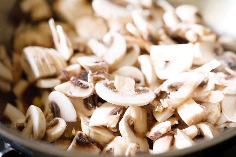 chopped button mushrooms added to the pan