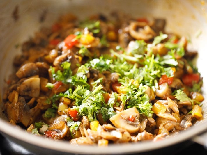 fresh cilantro added to veggie mix for burritos