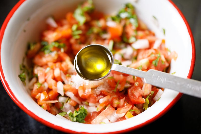 olive oil being added to veggie mix