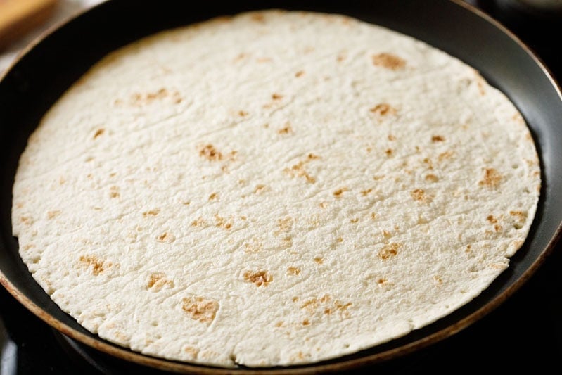 warming tortilla in a pan
