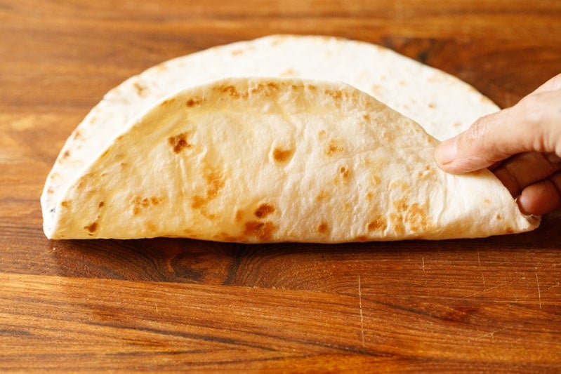 folding one side of the tortilla over the filling