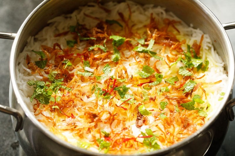 reserved fried onions and mint sprinkled over rice