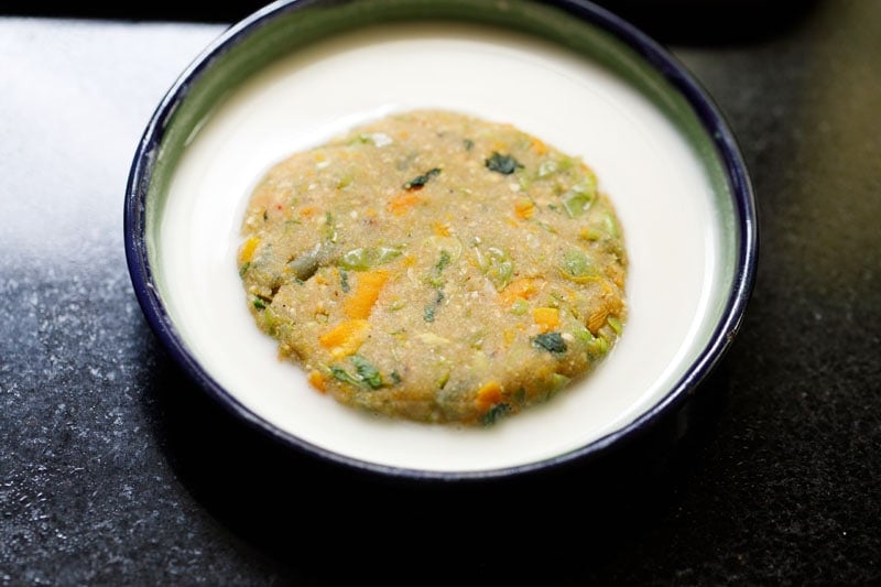 one vegetable cutlet patty dipped in the flour slurry