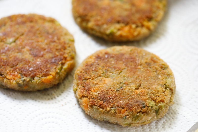 pan fried cutlets placed on kitchen paper towels