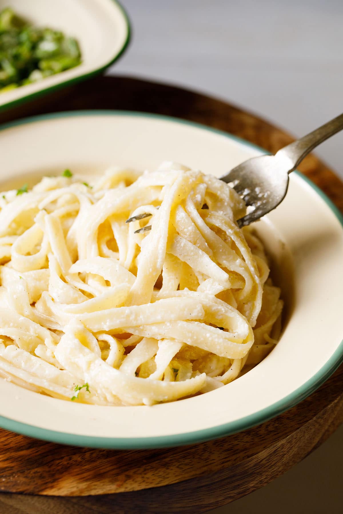 closeup shot of fettuccine alfredo being taken in a fork