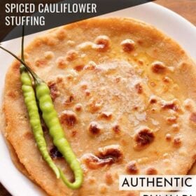 overhead shot of gobi paratha served on a white plate topped with 2 green chilies at the side with text layovers.