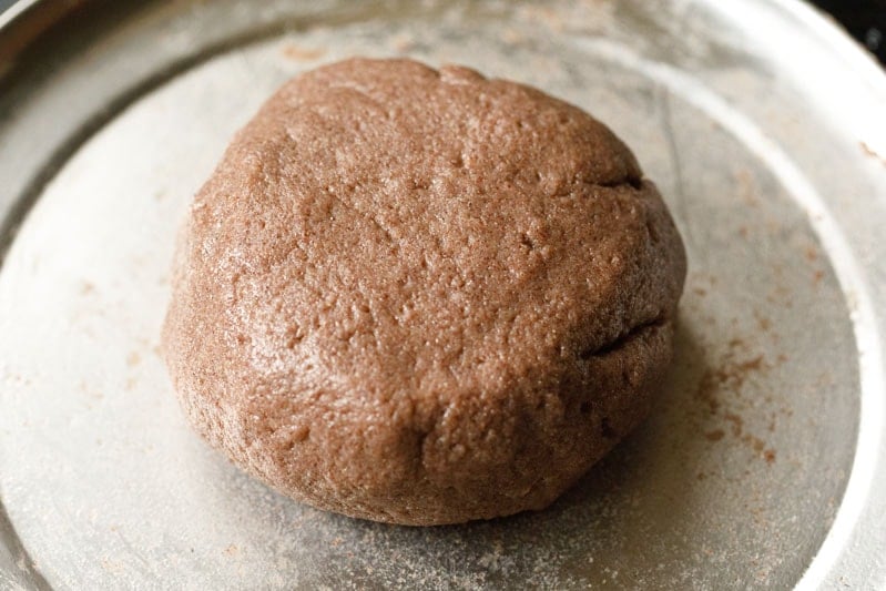 large ragi mudde patty in the middle of the tray after kneading