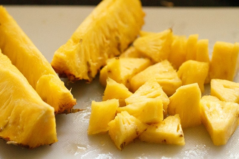 chopped pineapple pieces on a board